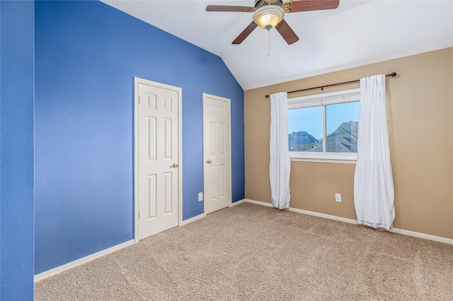 unfurnished bedroom with lofted ceiling, carpet floors, and ceiling fan