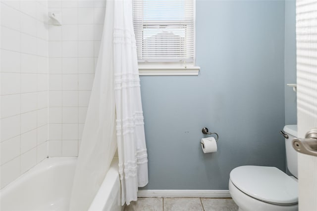 bathroom featuring tile patterned flooring, shower / tub combo, and toilet