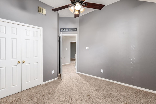 unfurnished bedroom with carpet floors, a closet, and ceiling fan