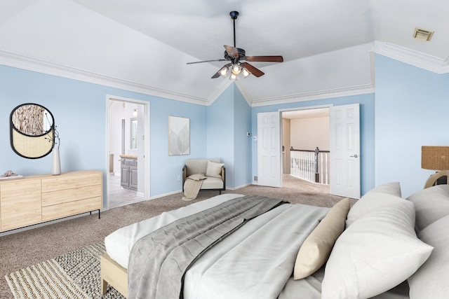 bedroom with crown molding, ensuite bath, lofted ceiling, and carpet floors