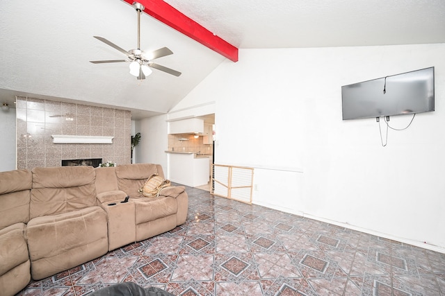 living room featuring a tiled fireplace, ceiling fan, and lofted ceiling with beams