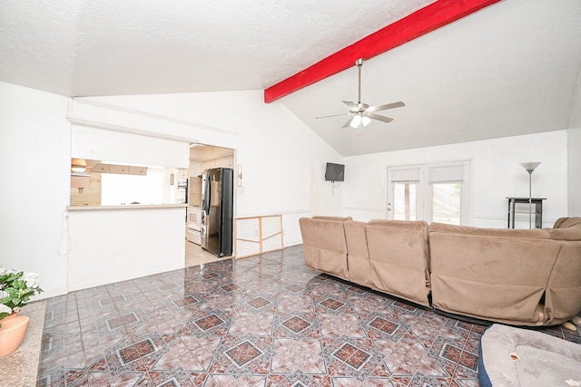 living room with a textured ceiling, lofted ceiling with beams, and ceiling fan