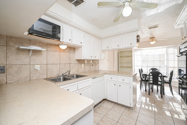 kitchen featuring kitchen peninsula, white dishwasher, white cabinetry, and sink