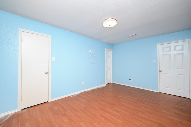 spare room with wood-type flooring