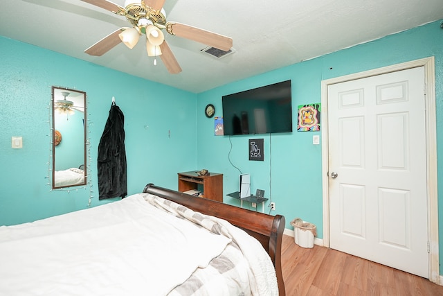 bedroom with ceiling fan and wood-type flooring