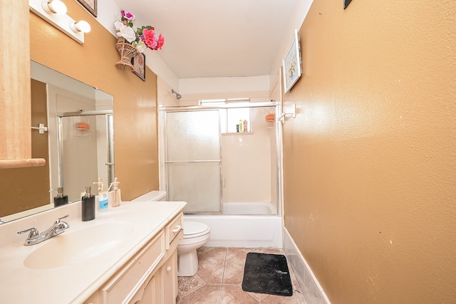 full bathroom featuring vanity, toilet, tile patterned floors, and combined bath / shower with glass door