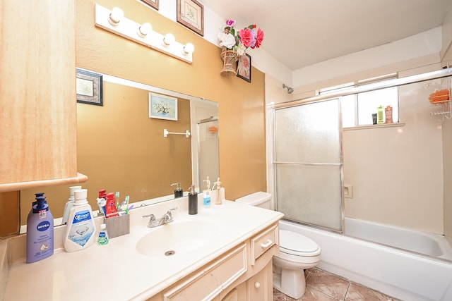 full bathroom with vanity, enclosed tub / shower combo, toilet, and tile patterned flooring