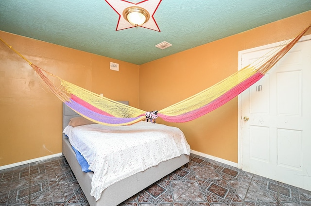 bedroom featuring a textured ceiling