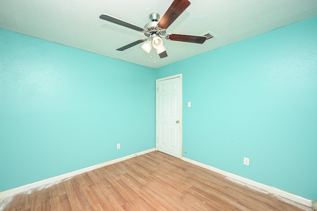 spare room with ceiling fan and light wood-type flooring