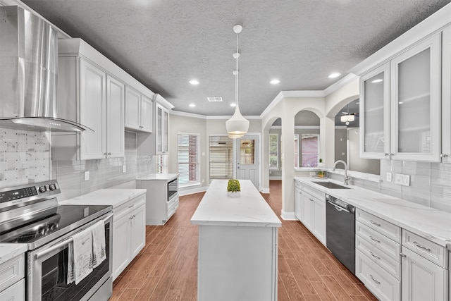 kitchen with stainless steel electric stove, white cabinetry, hardwood / wood-style flooring, and black dishwasher