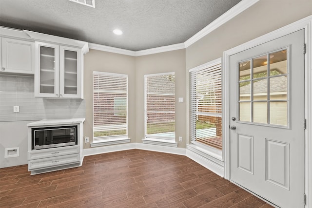 entryway with a textured ceiling, dark hardwood / wood-style floors, and plenty of natural light