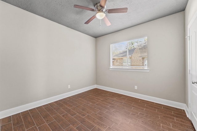 spare room featuring ceiling fan, dark hardwood / wood-style floors, and a textured ceiling