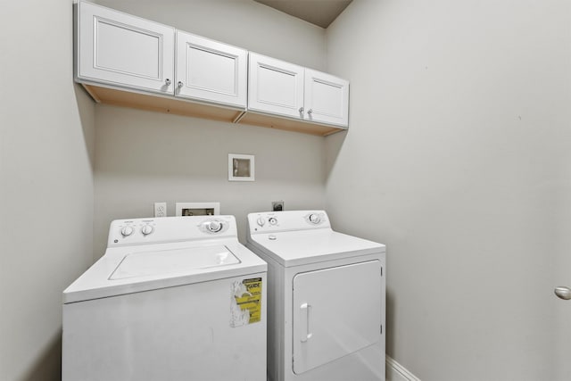 laundry room featuring cabinets and separate washer and dryer