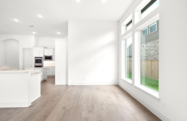 unfurnished living room featuring light hardwood / wood-style flooring