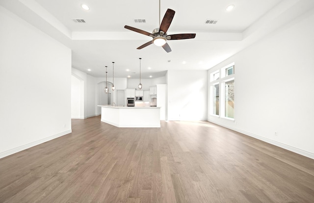 unfurnished living room featuring light hardwood / wood-style flooring and ceiling fan