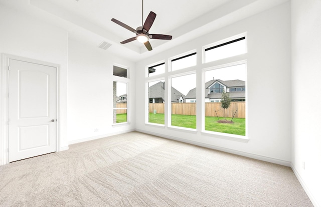 empty room with ceiling fan and light colored carpet