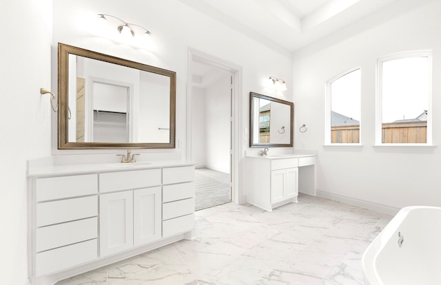 bathroom featuring vanity and a tub