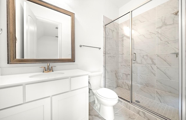 bathroom with vanity, toilet, and a shower with door