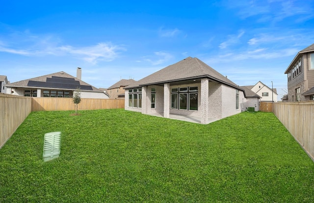 back of house with cooling unit and a lawn