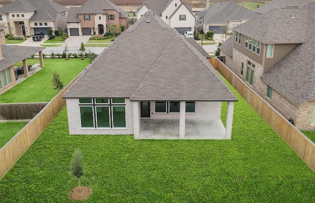 back of property featuring a lawn and a patio area