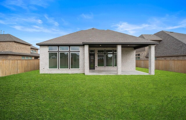 back of house featuring a yard and a patio area