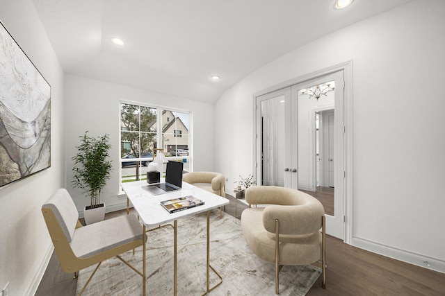 office space featuring vaulted ceiling, dark hardwood / wood-style floors, and an inviting chandelier