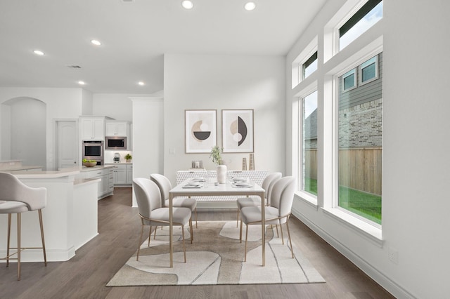 dining space with dark wood-type flooring