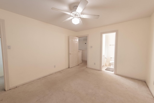 unfurnished bedroom featuring ceiling fan, light carpet, and ensuite bath