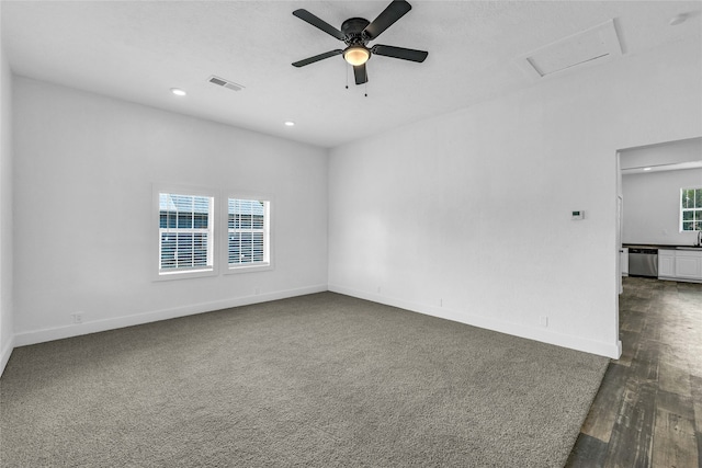 empty room with dark hardwood / wood-style flooring, ceiling fan, and sink