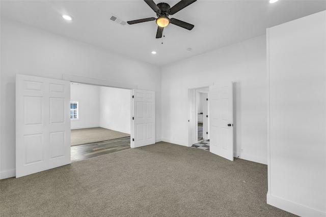 empty room featuring carpet flooring and ceiling fan