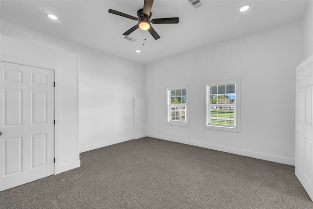 carpeted spare room with ceiling fan