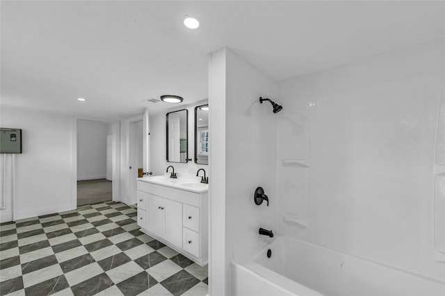 bathroom featuring washtub / shower combination and vanity