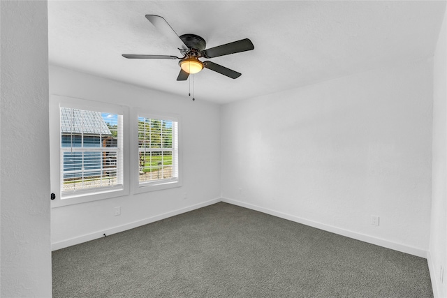 carpeted spare room with ceiling fan