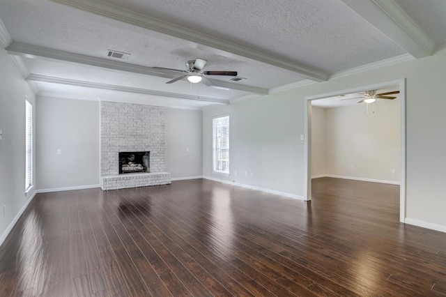 unfurnished living room featuring a fireplace, beamed ceiling, dark hardwood / wood-style flooring, crown molding, and a textured ceiling