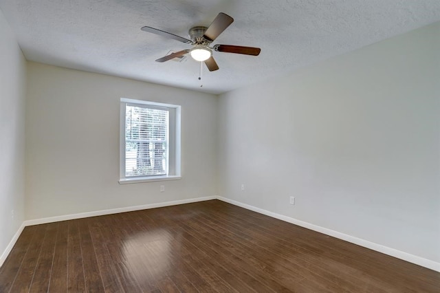 spare room featuring ceiling fan, dark wood-type flooring, and a textured ceiling