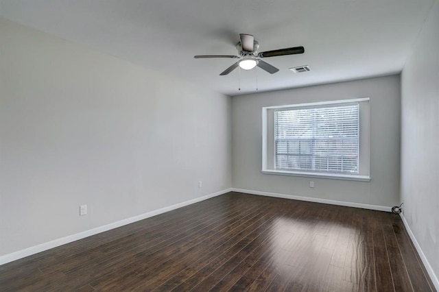 empty room with ceiling fan and dark wood-type flooring