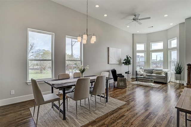 dining area featuring a high ceiling, dark hardwood / wood-style floors, and plenty of natural light