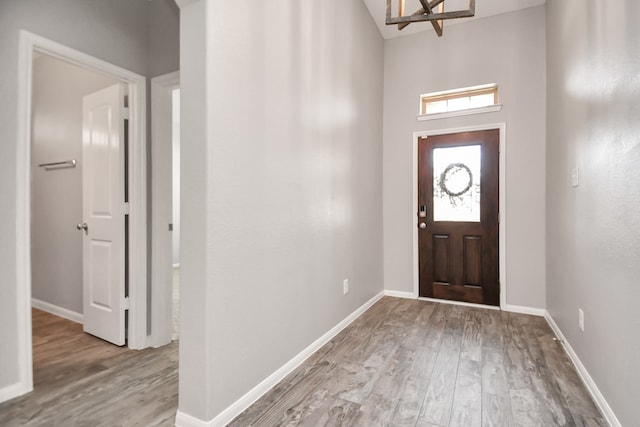 foyer featuring an inviting chandelier and light wood-type flooring