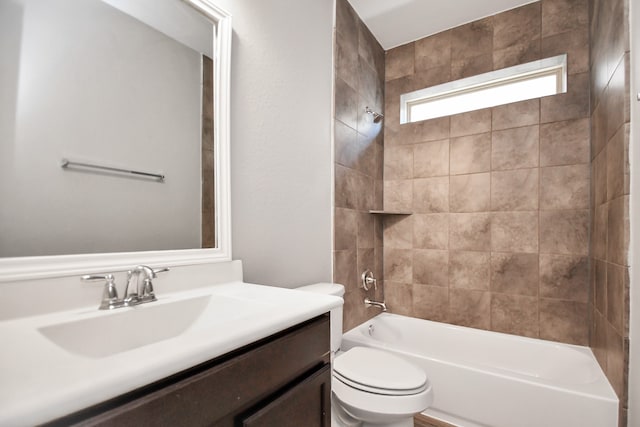 full bathroom with vanity, toilet, and tiled shower / bath