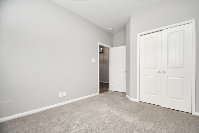 unfurnished bedroom featuring a closet and carpet