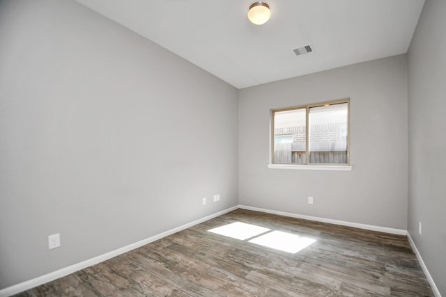 empty room with dark hardwood / wood-style floors