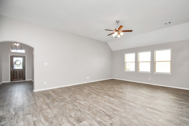 spare room with vaulted ceiling, ceiling fan, hardwood / wood-style flooring, and plenty of natural light