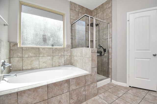 bathroom with tile patterned flooring and independent shower and bath