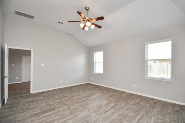 empty room with dark hardwood / wood-style flooring, ceiling fan, and lofted ceiling