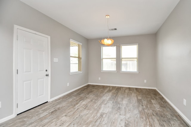 spare room featuring light hardwood / wood-style floors