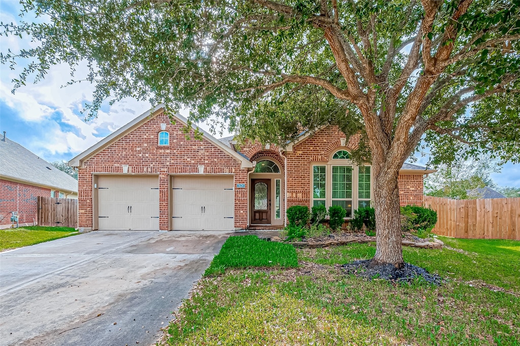 front of property featuring a front yard and a garage