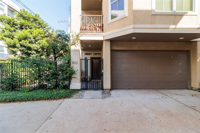 doorway to property with a balcony and a garage