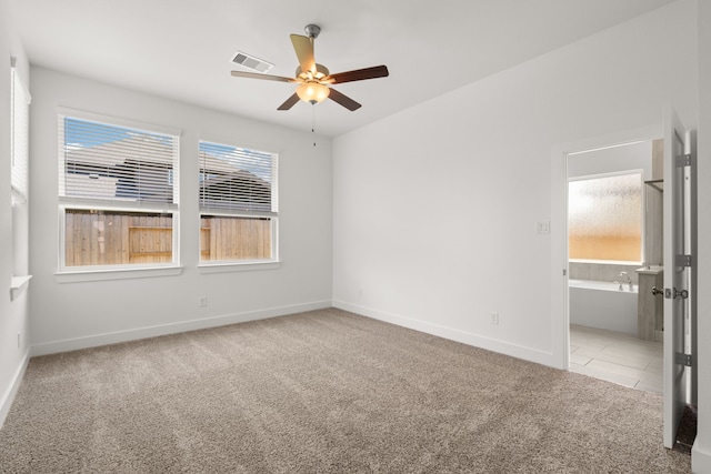 unfurnished room featuring light carpet and ceiling fan