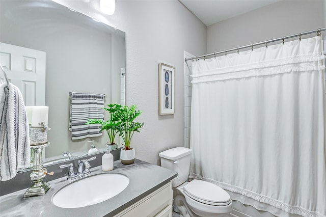 full bathroom with vanity, shower / bath combination with curtain, and toilet