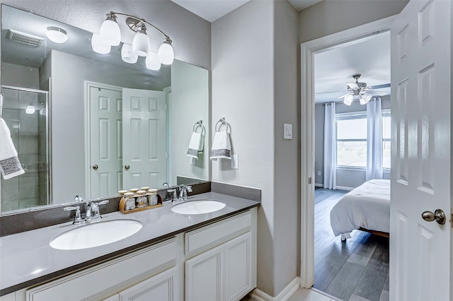 bathroom with vanity, hardwood / wood-style flooring, an enclosed shower, and ceiling fan